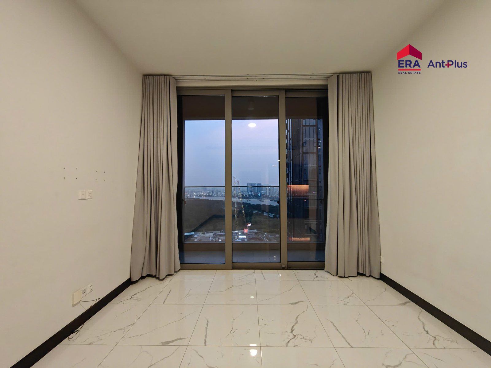 Phòng khách căn hộ Tilia với cửa kính ra ban công